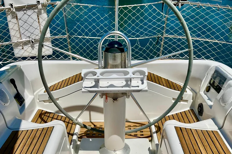 Slide: The Image of Cockpit of 1991 Beneteau First 38s5 sailboat with wooden flooring and steering wheel. - 4