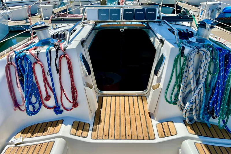 Slide: The Image of 1991 Beneteau First 38s5 sailboat cockpit with colorful ropes and wooden deck. - 5