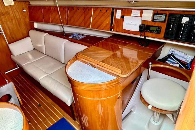 Slide: The Image of Interior of 1991 Beneteau First 38s5 yacht with wooden cabinetry and white seating. - 7