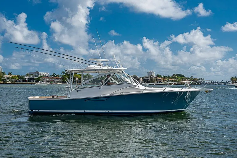 The Image of 2021 Viking 38 Open yacht cruising on a sunny day with blue skies. - 1
