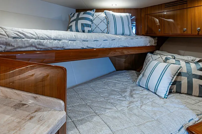 Slide: The Image of Interior of 2021 Viking 38 Open yacht with cozy bunk beds and stylish pillows. - 15