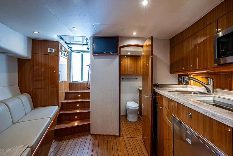 Slide: The Image of Luxurious interior of 2021 Viking 38 Open yacht with modern kitchen and seating area. - 16