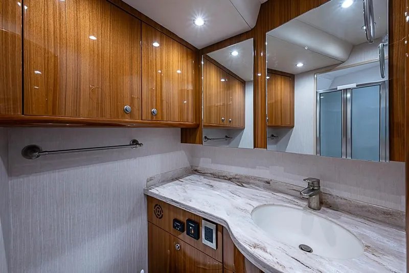 Slide: The Image of Luxurious bathroom interior of 2021 Viking 38 Open yacht with wooden cabinets and marble countertop. - 18