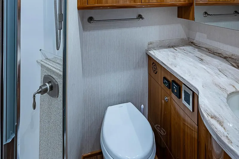 Slide: The Image of Luxurious bathroom in 2021 Viking 38 Open yacht with modern fixtures and wooden cabinetry. - 19