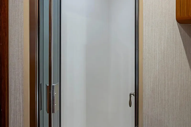 Slide: The Image of Shower door inside 2021 Viking 38 Open yacht, featuring sleek modern design. - 21