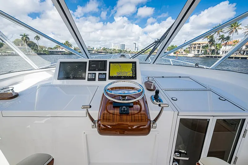 Slide: The Image of Helm of 2021 Viking 38 Open yacht with navigation screens and steering wheel. - 29