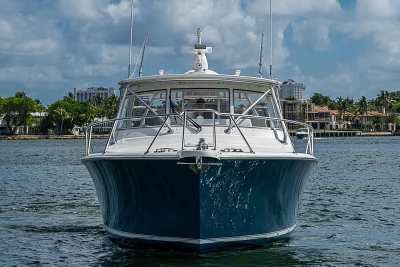 Slide: The Image of 2021 Viking 38 Open yacht on water, front view with coastal background. - 3