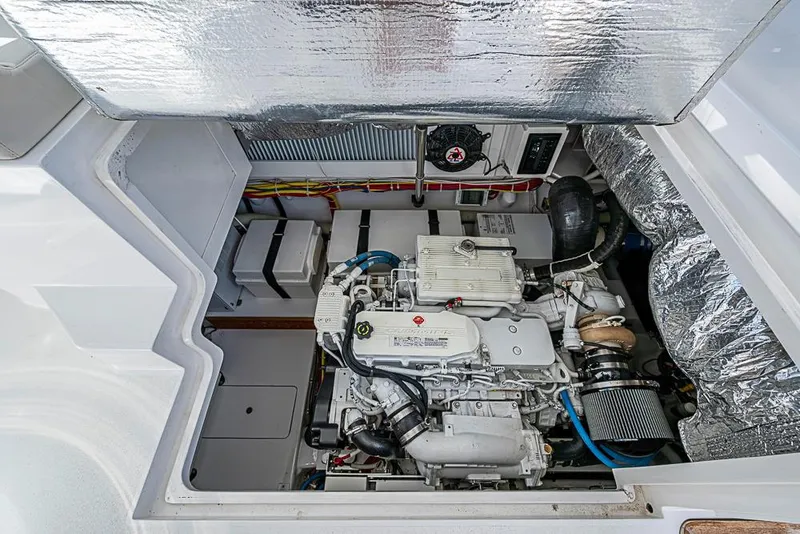 Slide: The Image of Engine compartment of 2021 Viking 38 Open yacht, showcasing detailed mechanical components. - 38