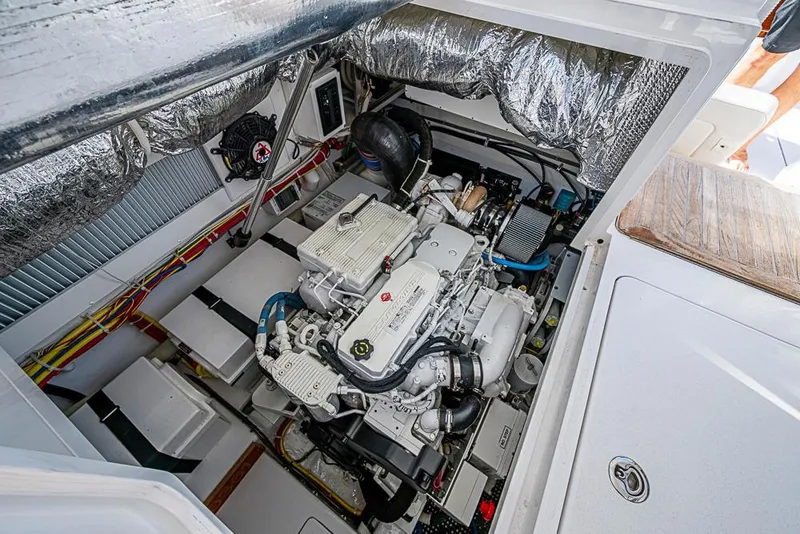 Slide: The Image of Engine compartment of 2021 Viking 38 Open boat, showcasing detailed mechanical components. - 39