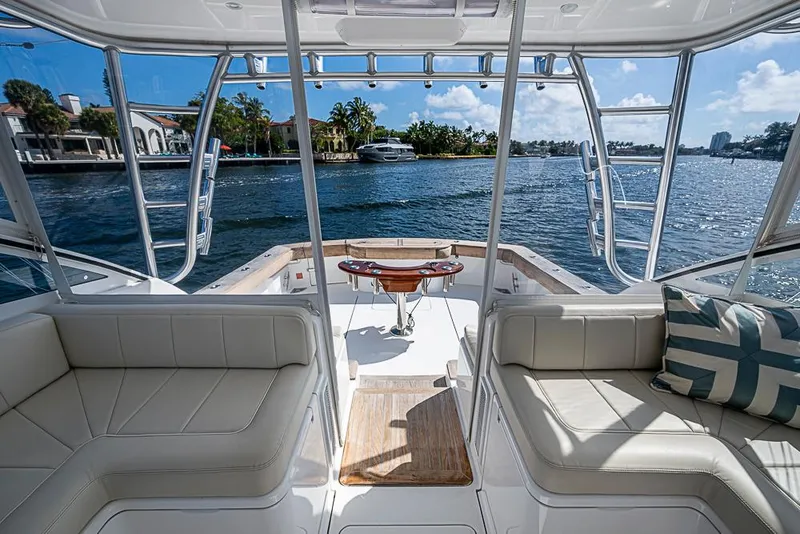 Slide: The Image of 2021 Viking 38 Open yacht interior with waterfront view, featuring comfortable seating and elegant design. - 44