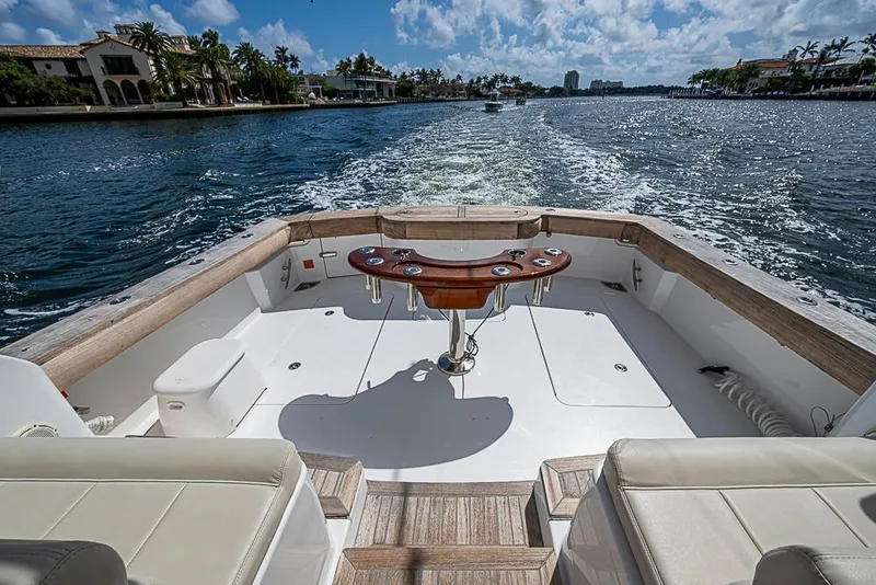 Slide: The Image of 2021 Viking 38 Open boat cruising on a sunny day, featuring spacious deck and luxurious seating. - 45