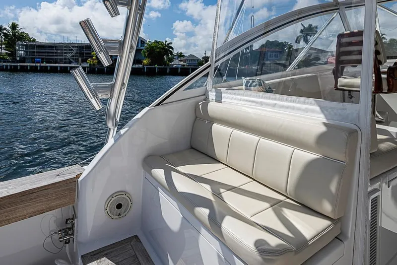 Slide: The Image of 2021 Viking 38 Open yacht interior with beige seating and waterfront view. - 47