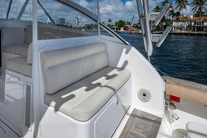 Slide: The Image of 2021 Viking 38 Open yacht interior with white seating, dockside view. - 49