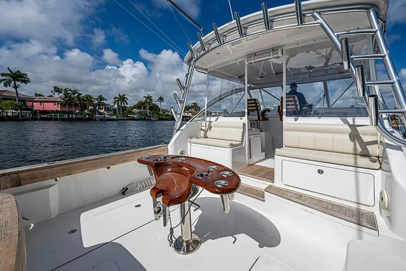 Slide: The Image of 2021 Viking 38 Open yacht with spacious deck and seating, cruising on a sunny day. - 50