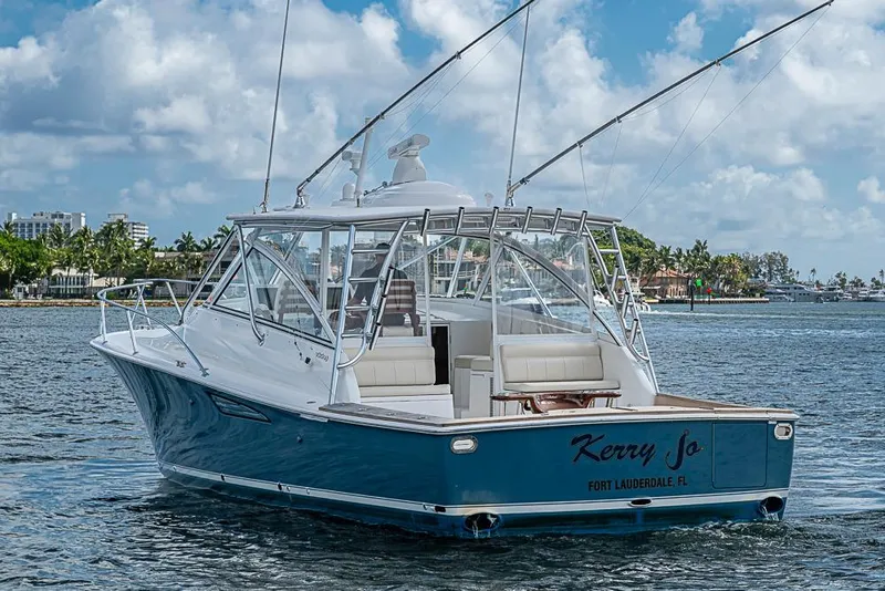 Slide: The Image of 2021 Viking 38 Open yacht on water, Fort Lauderdale backdrop, blue hull, sunny day. - 56