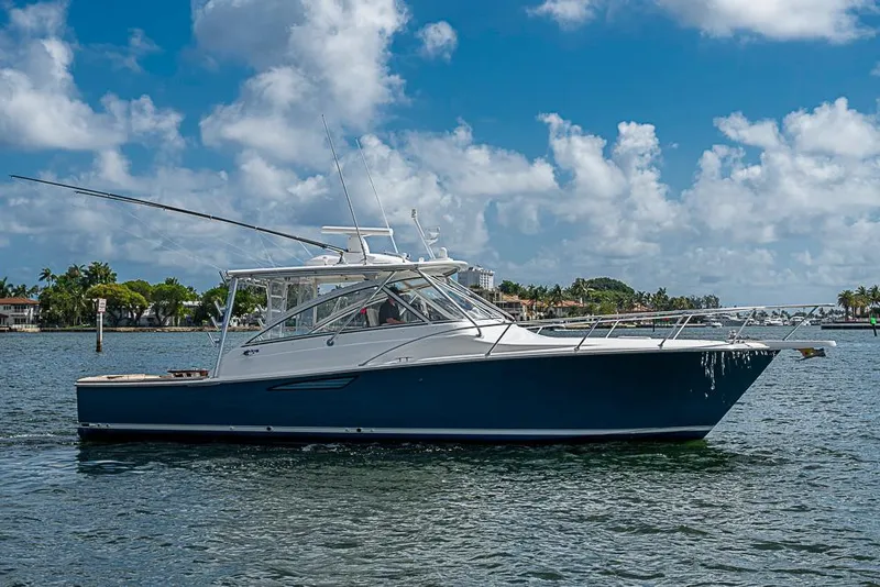 Slide: The Image of 2021 Viking 38 Open boat on water under blue sky with clouds. - 58
