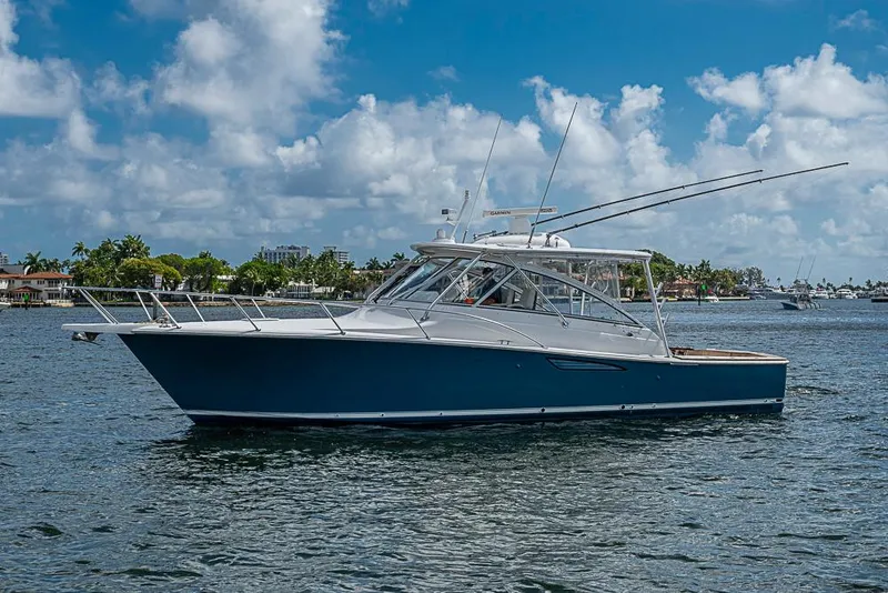 Slide: The Image of 2021 Viking 38 Open yacht on calm water under a blue sky. - 59