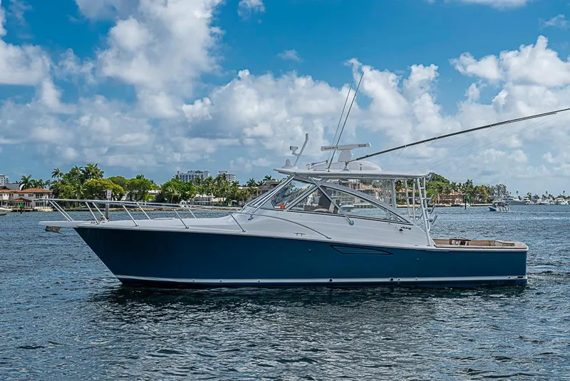 Slide: The Image of 2021 Viking 38 Open yacht on calm water under a blue sky. - 6