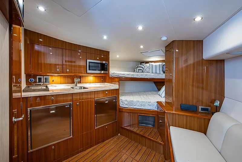 Slide: The Image of Luxurious interior of 2021 Viking 38 Open yacht with modern kitchen and cozy sleeping area. - 7