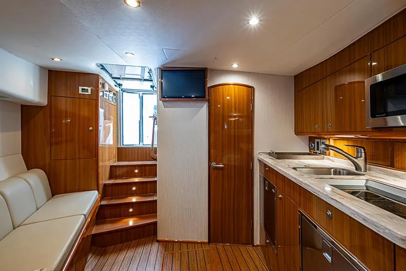 Slide: The Image of Luxurious interior of 2021 Viking 38 Open yacht with modern kitchen and seating area. - 8