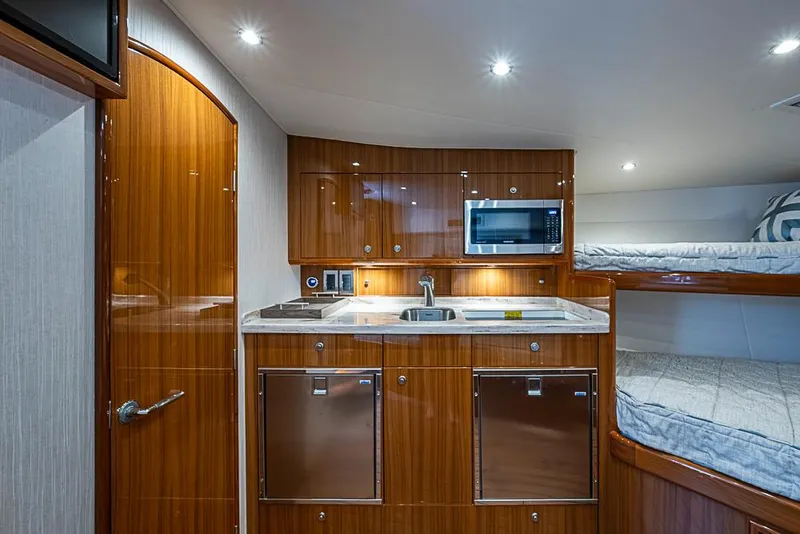 Slide: The Image of Luxurious interior of 2021 Viking 38 Open yacht with modern kitchen and cozy sleeping area. - 9