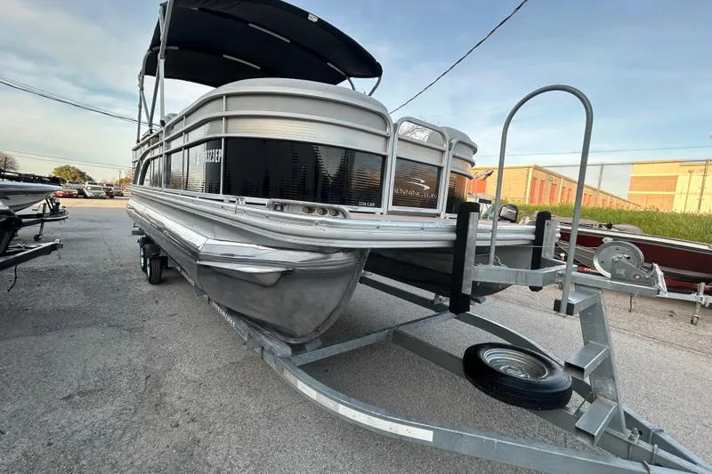 Slide: The Image of 2014 Bennington G22 boat trailer with winch and spare tire in a parking lot. - 10