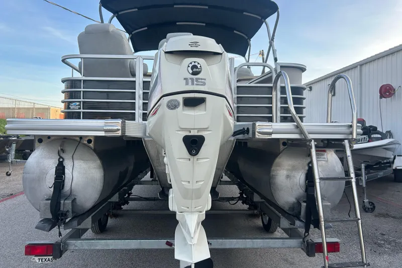 Slide: The Image of Dual wheels on a 2014 Bennington G22 trailer, parked on asphalt. - 14