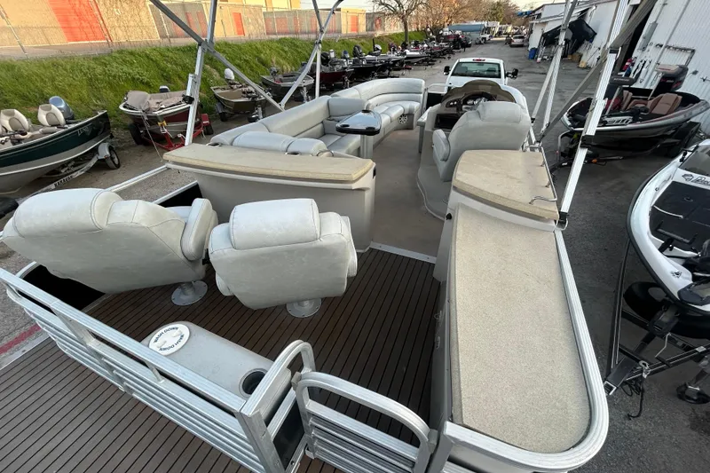 Slide: The Image of 2014 Bennington G22 pontoon boat interior with plush seating and steering console. - 20