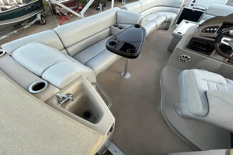 Slide: The Image of 2014 Bennington G22 pontoon boat interior with plush seating and cup holders. - 23