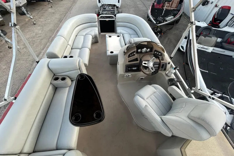 Slide: The Image of 2014 Bennington G22 pontoon boat interior with plush seating and cup holders. - 24
