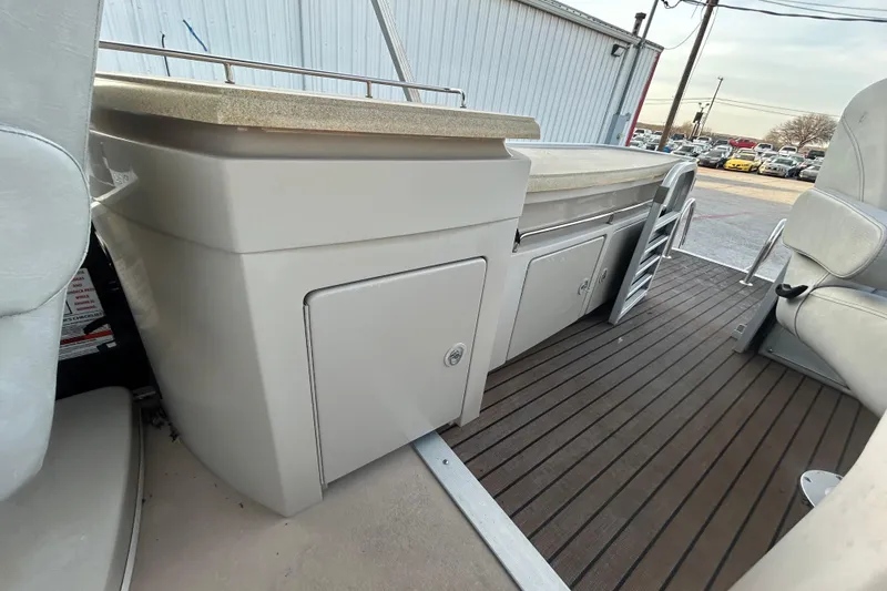 Slide: The Image of 2014 Bennington G22 boat control panel with keys and safety equipment. - 28