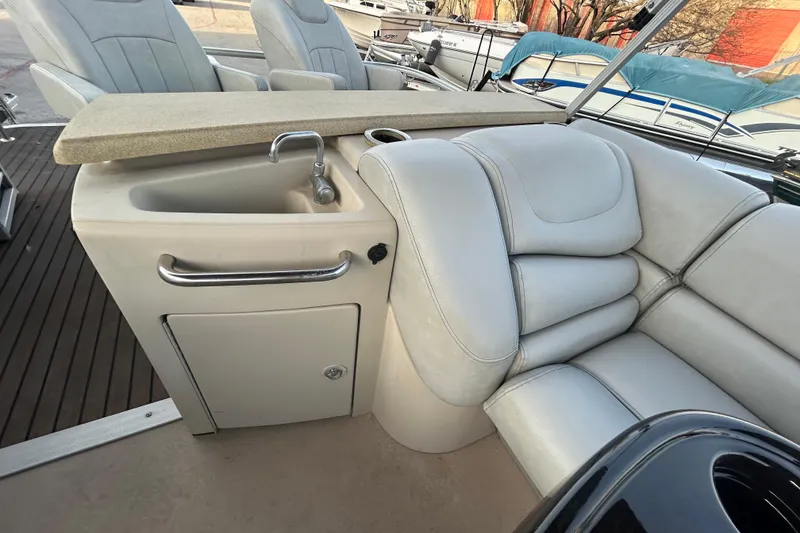 Slide: The Image of 2014 Bennington G22 boat deck with "Wash Down" cap on wooden flooring. - 31