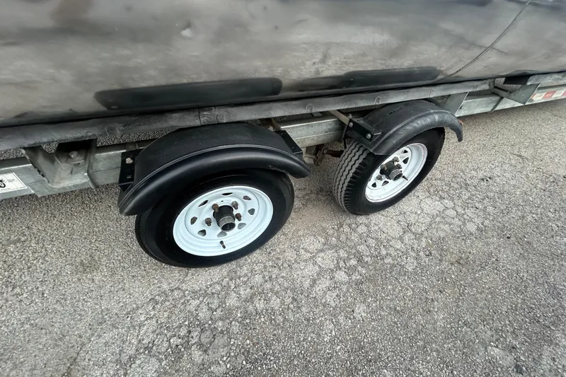 Slide: The Image of 2014 Bennington G22 boat storage compartment with open door and visible wiring. - 37