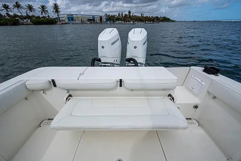 Slide: The Image of 2007 Triton 351 CC boat with twin Mercury engines on calm water. - 10