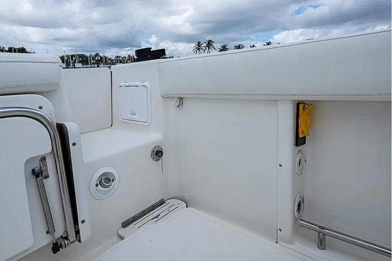 Slide: The Image of 2007 Triton 351 CC boat interior with white seating and storage compartments. - 13