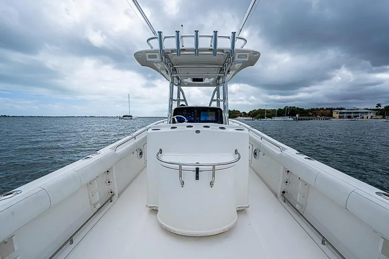 Slide: The Image of 2007 Triton 351 CC boat on water under cloudy sky. - 19