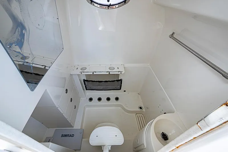 Slide: The Image of 2007 Triton 351 CC boat interior with compact bathroom and Simrad equipment. - 21