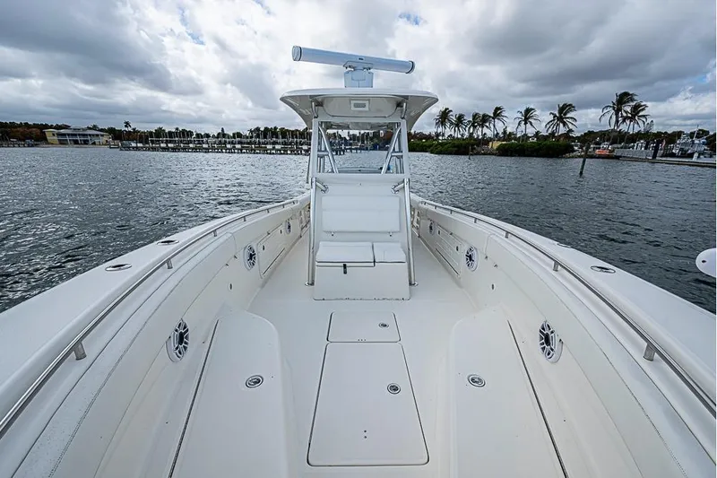Slide: The Image of 2007 Triton 351 CC boat on water, featuring spacious deck and modern design. - 25