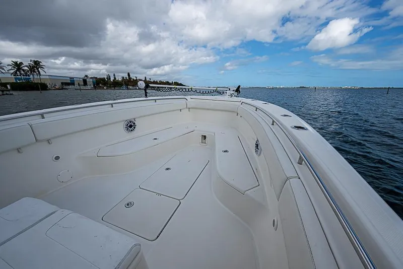 Slide: The Image of 2007 Triton 351 CC boat deck with ocean view, under partly cloudy sky. - 27