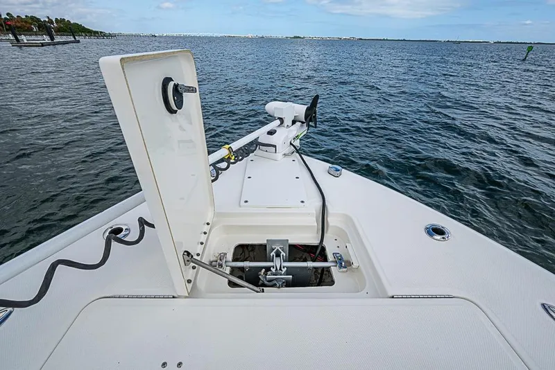 Slide: The Image of 2007 Triton 351 CC boat with open hatch and trolling motor on calm water. - 33
