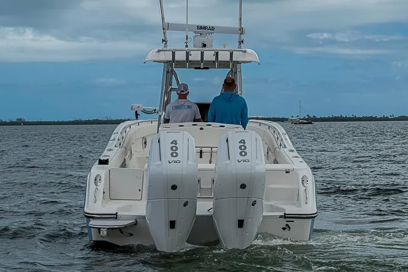 Slide: The Image of 2007 Triton 351 CC boat with dual 400 V10 engines on open water. - 4