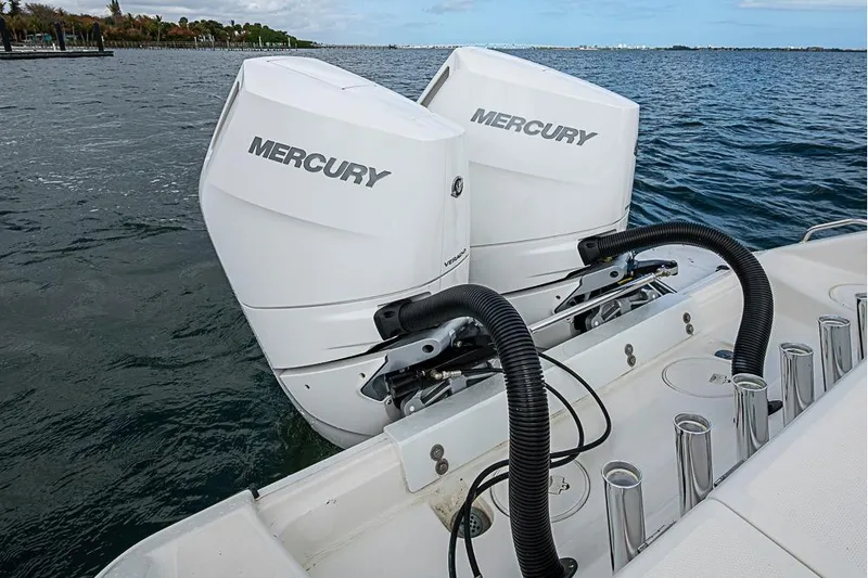 Slide: The Image of Twin Mercury outboard engines on a 2007 Triton 351 CC boat, cruising on open water. - 7