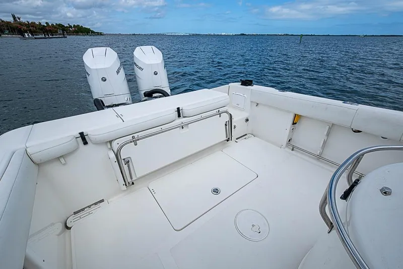 Slide: The Image of 2007 Triton 351 CC boat deck with twin Mercury engines on calm water. - 8