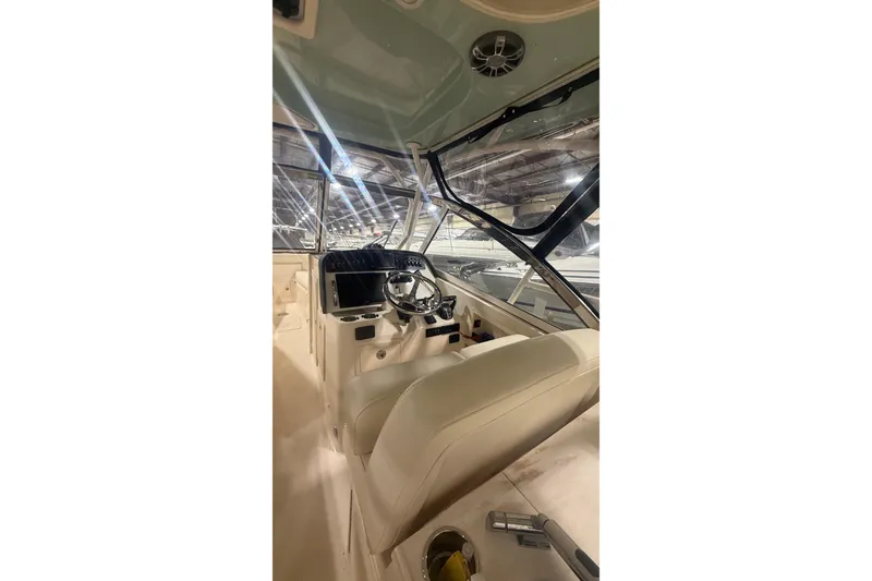 Slide: The Image of 2022 Grady-White Freedom 307 boat interior with steering wheel and dashboard. - 10