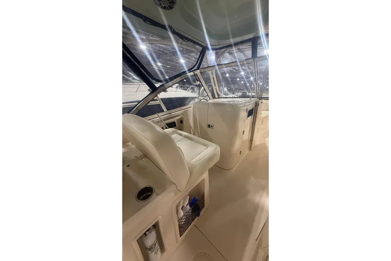 Slide: The Image of 2022 Grady-White Freedom 307 boat interior with seating and helm station. - 11
