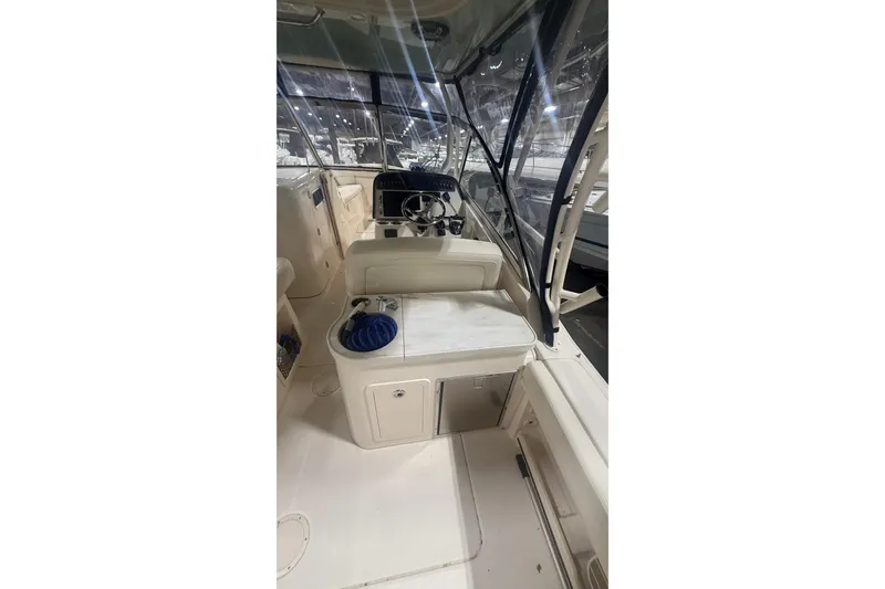 Slide: The Image of 2022 Grady-White Freedom 307 boat interior with helm and seating area. - 12
