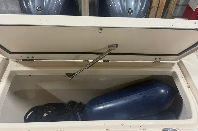 Slide: The Image of Open storage compartment on 2022 Grady-White Freedom 307 boat with fender and rope. - 14