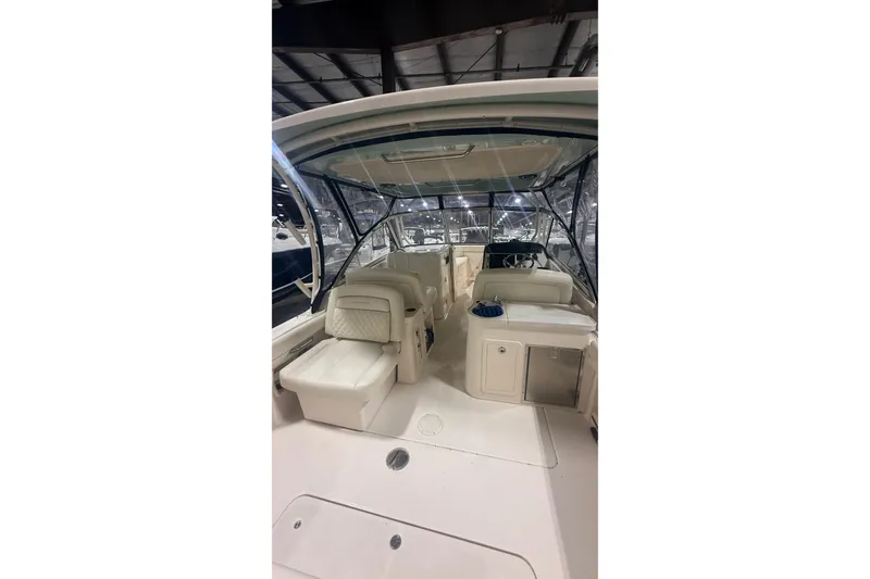 Slide: The Image of 2022 Grady-White Freedom 307 boat interior with seating and helm under a canopy. - 15