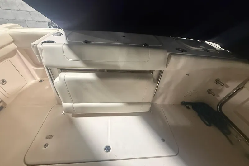 Slide: The Image of 2022 Grady-White Freedom 307 boat interior with foldable seating and storage compartments. - 25