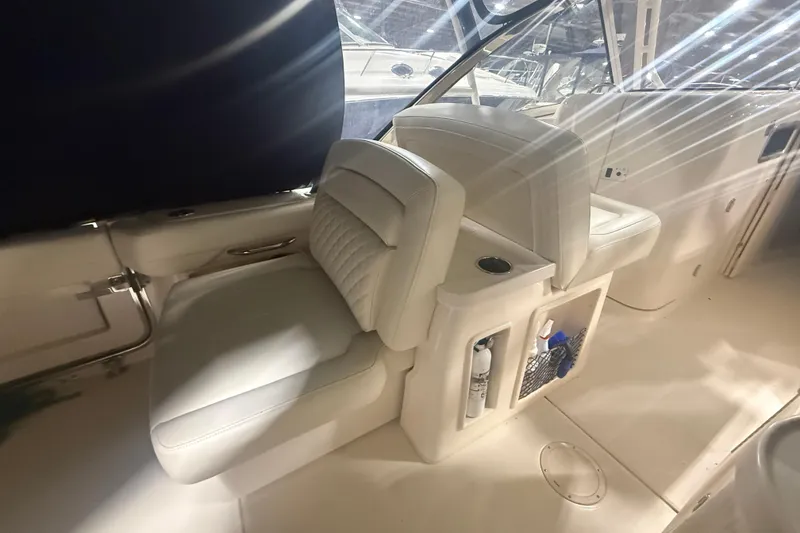 Slide: The Image of 2022 Grady-White Freedom 307 boat interior with white seating and storage compartments. - 28